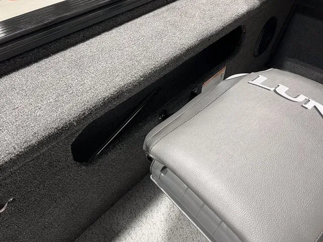 Slide: The Image of 2025 Lund 2075 Pro-V Bass XS interior with gray seating and carpeted storage area. - 16