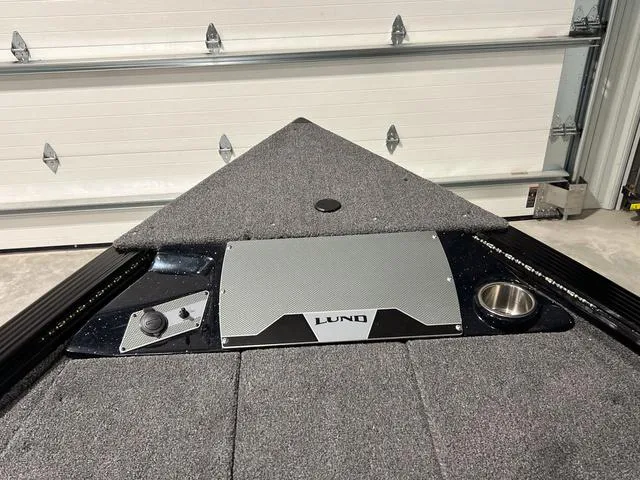 Slide: The Image of 2025 Lund 2075 Pro-V Bass XS boat interior with carpeted deck and control panel. - 29