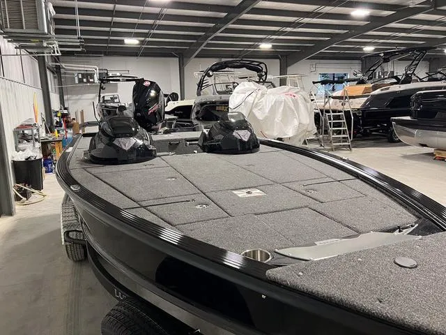 Slide: The Image of 2025 Lund 2075 Pro-V Bass XS boat in showroom, featuring spacious deck and modern design. - 3