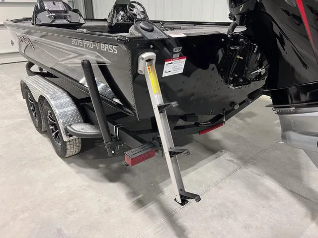 Slide: The Image of 2025 Lund 2075 Pro-V Bass XS boat with trailer and ladder in a garage. - 5