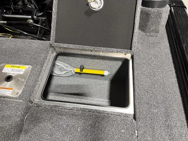 Slide: The Image of 2025 Lund 2075 Pro-V Bass XS storage compartment with safety equipment. - 7