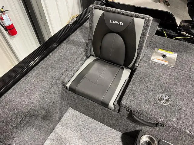 Slide: The Image of 2025 Lund 2075 Pro-V Bass XS boat seat with gray upholstery and storage compartments. - 9