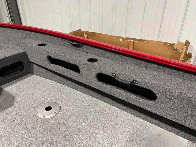 Slide: The Image of 2024 Lund 1775 Pro Guide Tiller boat interior with storage compartments. - 10