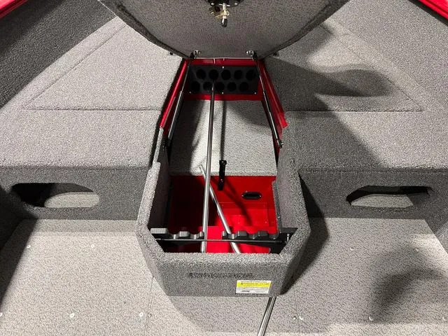 Slide: The Image of 2024 Lund 1775 Pro Guide Tiller boat interior with open storage compartment. - 12