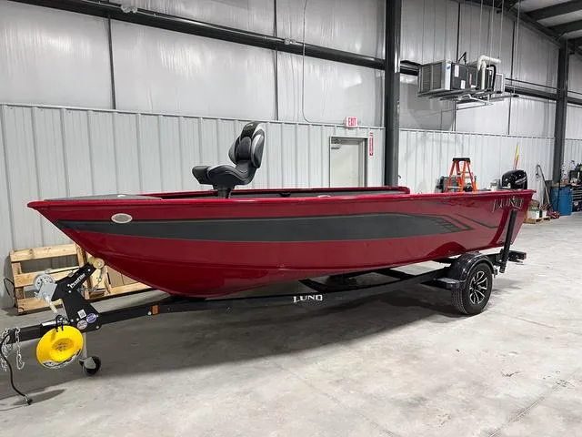 Slide: The Image of 2024 Lund 1775 Pro Guide Tiller boat in a warehouse setting. - 2