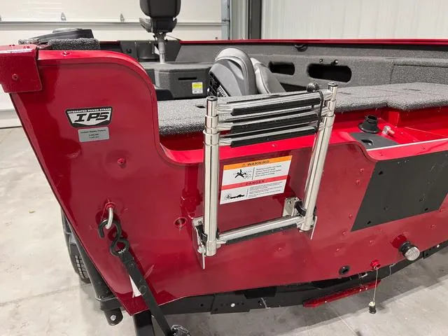 Slide: The Image of 2024 Lund 1775 Pro Guide Tiller boat, red exterior, with ladder and IPS technology. - 3