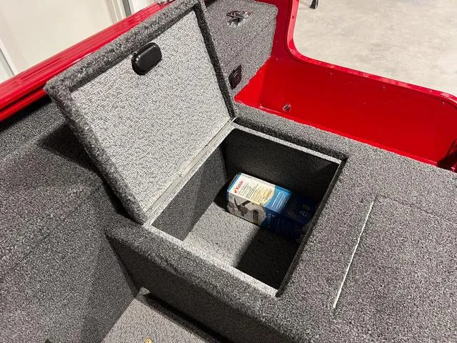 Slide: The Image of 2024 Lund 1775 Pro Guide Tiller storage compartment with a box inside. - 5