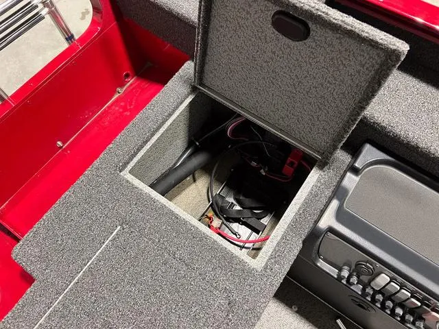 Slide: The Image of 2024 Lund 1775 Pro Guide Tiller boat storage compartment with wiring and equipment. - 7