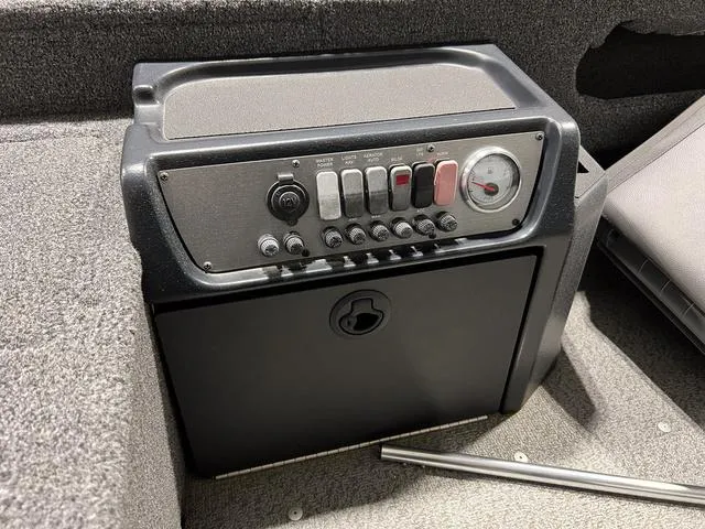 Slide: The Image of 2024 Lund 1775 Pro Guide Tiller control panel with switches and gauge. - 8