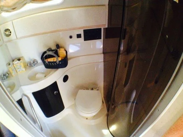 Slide: The Image of 1995 Wellcraft 3600 Martinique bathroom with toilet, sink, and shower. - 10