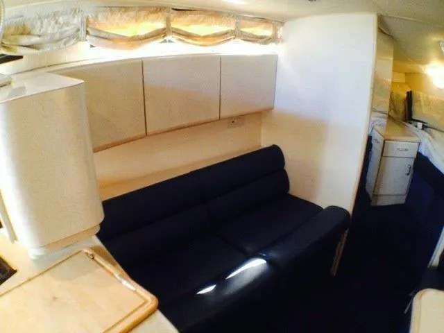 Slide: The Image of Interior of 1995 Wellcraft 3600 Martinique yacht with navy sofa and white cabinets. - 11