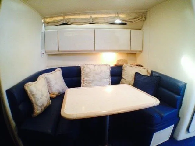 Slide: The Image of 1995 Wellcraft 3600 Martinique interior with blue seating and white table. - 12