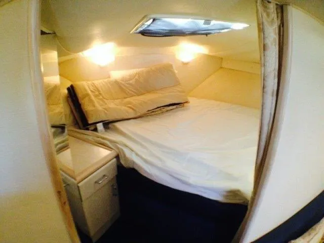 Slide: The Image of Cozy cabin interior of 1995 Wellcraft 3600 Martinique yacht with bed and soft lighting. - 13