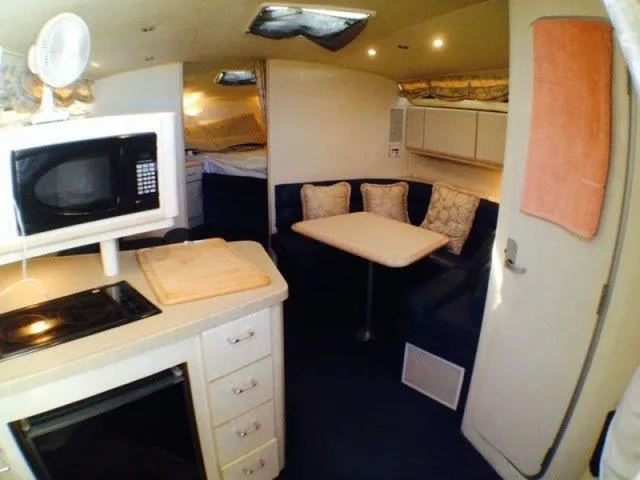 Slide: The Image of Interior of 1995 Wellcraft 3600 Martinique yacht with kitchen and dining area. - 14
