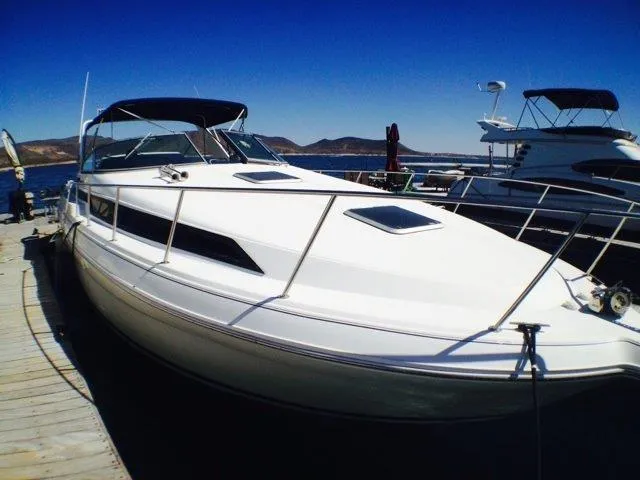 Slide: The Image of 1995 Wellcraft 3600 Martinique yacht docked at marina under clear blue sky. - 16