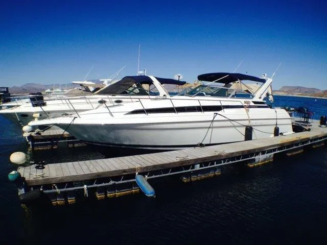 Slide: The Image of 1995 Wellcraft 3600 Martinique yacht docked at marina under clear blue sky. - 17