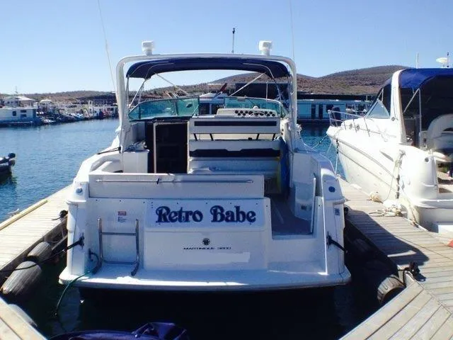 Slide: The Image of 1995 Wellcraft 3600 Martinique boat named "Retro Babe" docked at a marina. - 18