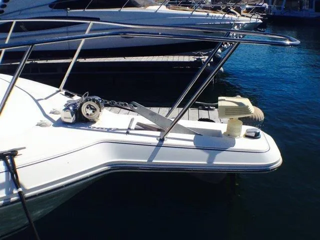 Slide: The Image of 1995 Wellcraft 3600 Martinique boat docked at marina, featuring anchor and railing. - 20