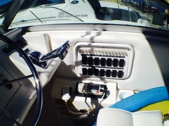 Slide: The Image of 1995 Wellcraft 3600 Martinique boat dashboard with controls and radio. - 23