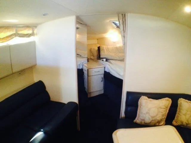 Slide: The Image of Interior of 1995 Wellcraft 3600 Martinique yacht with cozy seating and sleeping area. - 26