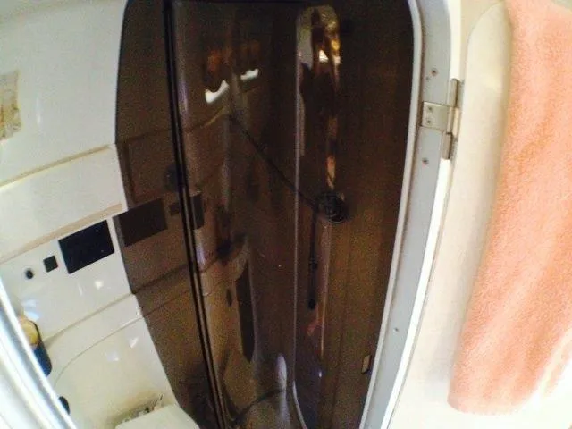Slide: The Image of Interior of 1995 Wellcraft 3600 Martinique boat with brown door and pink towel. - 27