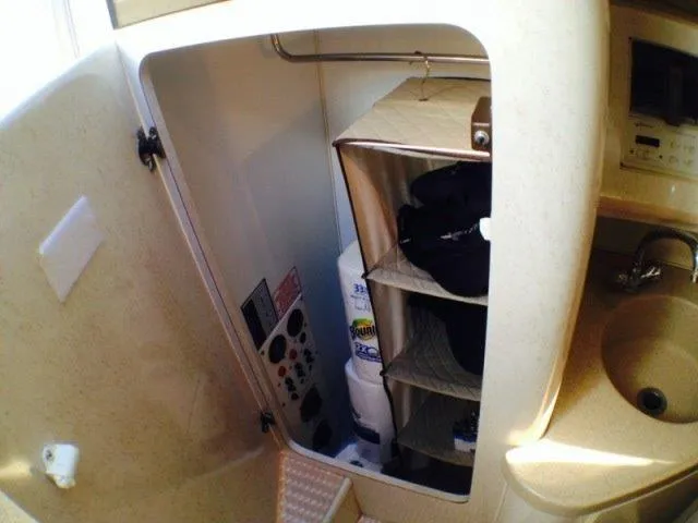Slide: The Image of 1995 Wellcraft 3600 Martinique boat interior storage and sink area. - 31