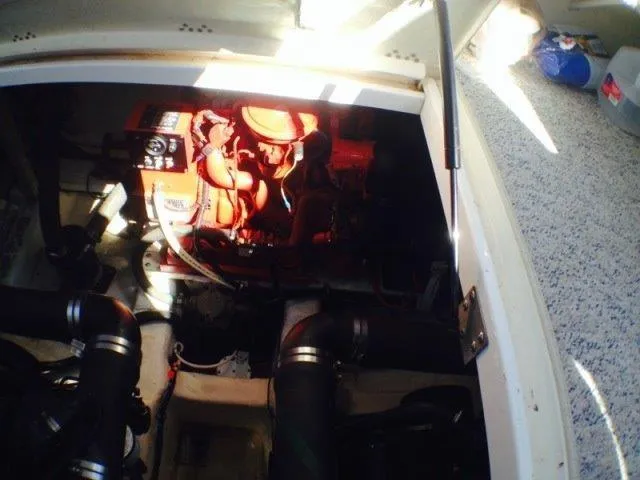 Slide: The Image of Engine compartment of 1995 Wellcraft 3600 Martinique boat, showcasing mechanical components. - 32