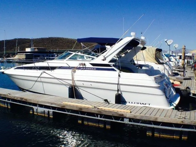 Slide: The Image of 1995 Wellcraft 3600 Martinique yacht docked at marina under clear blue sky. - 4