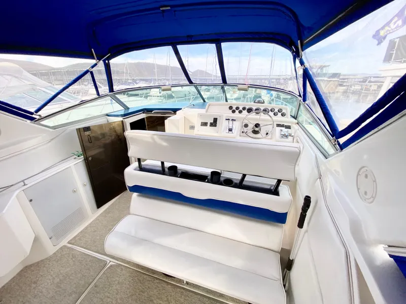 Slide: The Image of 1995 Wellcraft 3600 Martinique boat interior with blue canopy and white seating. - 5