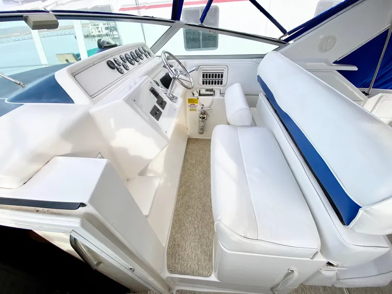 Slide: The Image of 1995 Wellcraft 3600 Martinique boat interior with white seating and control panel. - 7