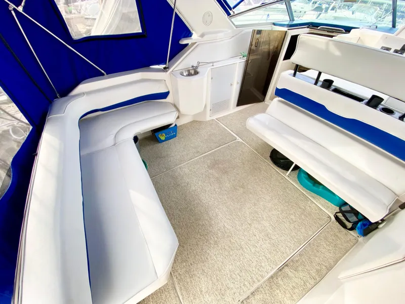 Slide: The Image of 1995 Wellcraft 3600 Martinique boat interior with white seating and blue accents. - 8