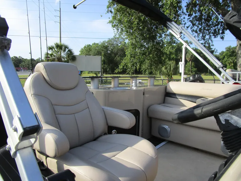 Slide: The Image of 2013 Sweetwater Premium SW 220 WB boat interior with beige seating and steering wheel. - 3
