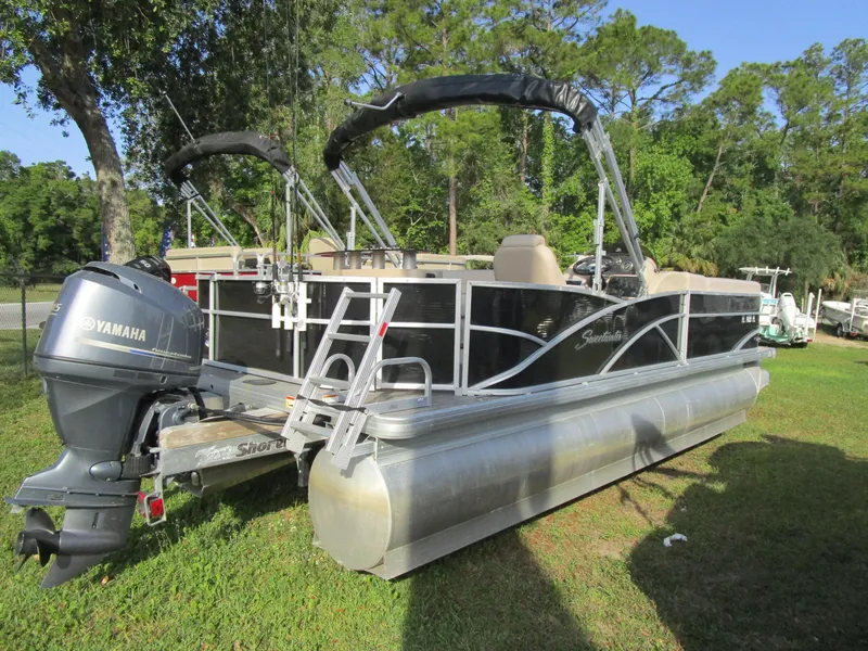 Slide: The Image of 2013 Sweetwater Premium SW 220 WB pontoon boat with Yamaha motor, parked on grass. - 6