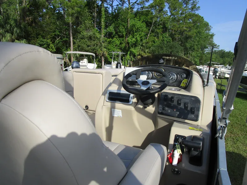 Slide: The Image of Interior view of 2013 Sweetwater Premium SW 220 WB boat with steering wheel and control panel. - 7
