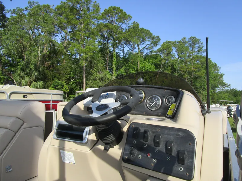 Slide: The Image of 2013 Sweetwater Premium SW 220 WB boat dashboard with steering wheel and controls. - 8