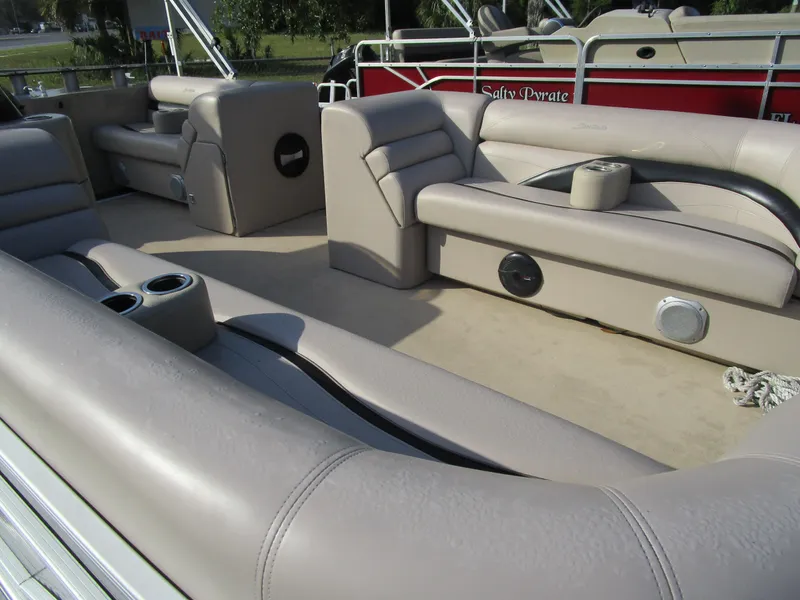Slide: The Image of 2013 Sweetwater Premium SW 220 WB pontoon boat with beige seating and cup holders. - 9