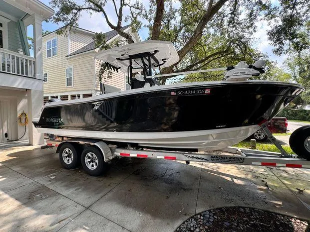 Slide: The Image of 2021 Blackfin 252 CC boat on trailer in residential driveway. - 1