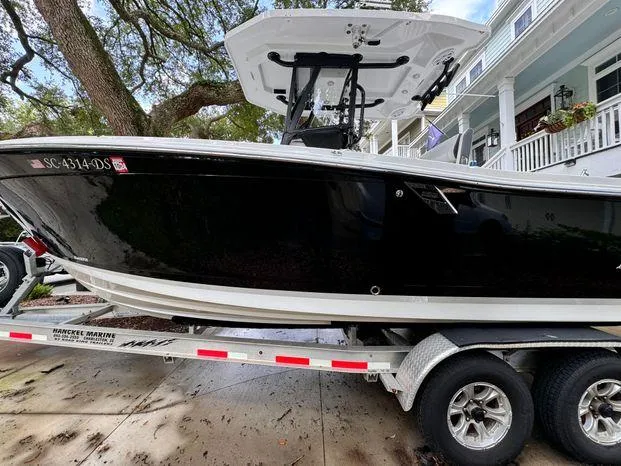 Slide: The Image of 2021 Blackfin 252 CC boat on trailer, parked near residential area. - 13