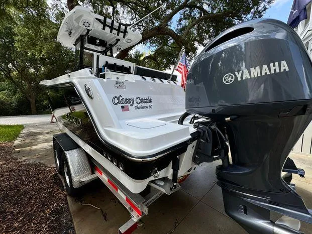 Slide: The Image of 2021 Blackfin 252 CC boat with Yamaha engine on trailer, parked outdoors. - 15