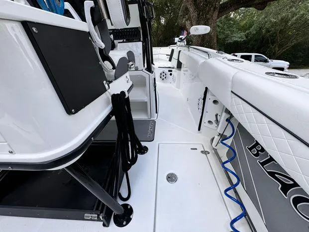 Slide: The Image of 2021 Blackfin 252 CC boat interior with seating and storage compartments. - 19
