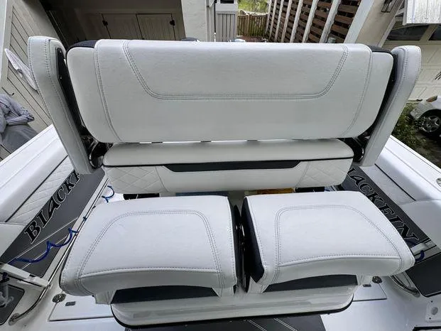 Slide: The Image of 2021 Blackfin 252 CC boat seating with white upholstery and sleek design. - 21