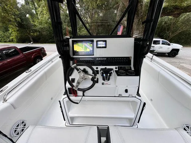 Slide: The Image of 2021 Blackfin 252 CC boat cockpit with steering wheel and navigation display. - 22