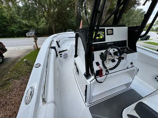 Slide: The Image of 2021 Blackfin 252 CC boat interior with steering console and seating. - 25