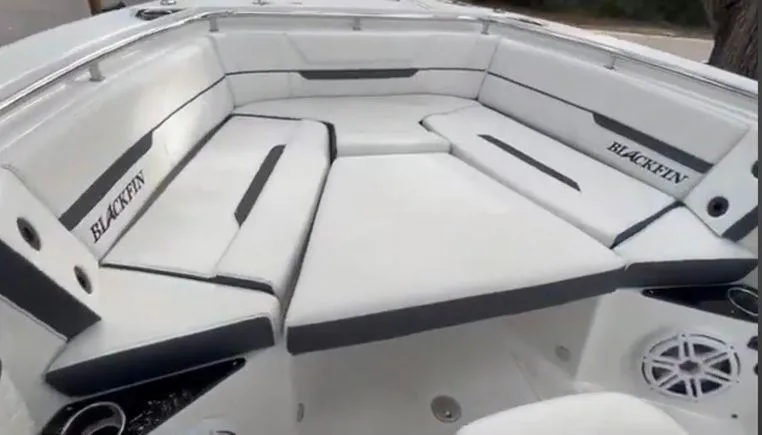 Slide: The Image of 2021 Blackfin 252 CC boat interior with white cushioned seating. - 27