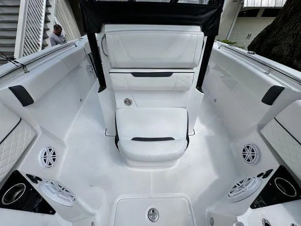 Slide: The Image of 2021 Blackfin 252 CC boat interior with white seating and speakers. - 31