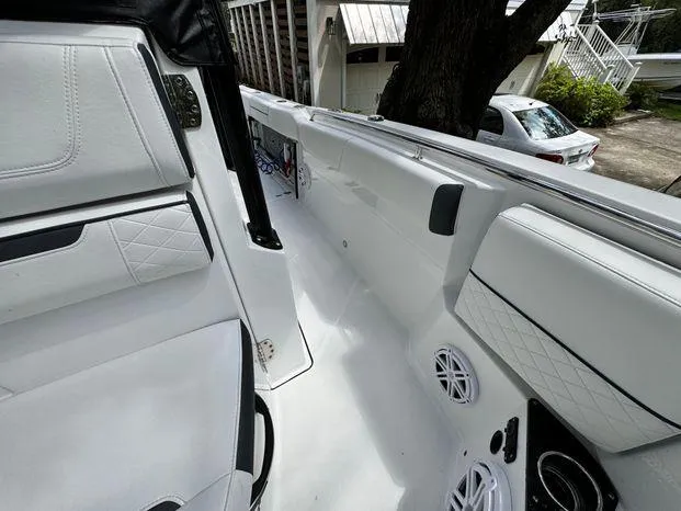 Slide: The Image of 2021 Blackfin 252 CC boat interior with white seating and speakers. - 34
