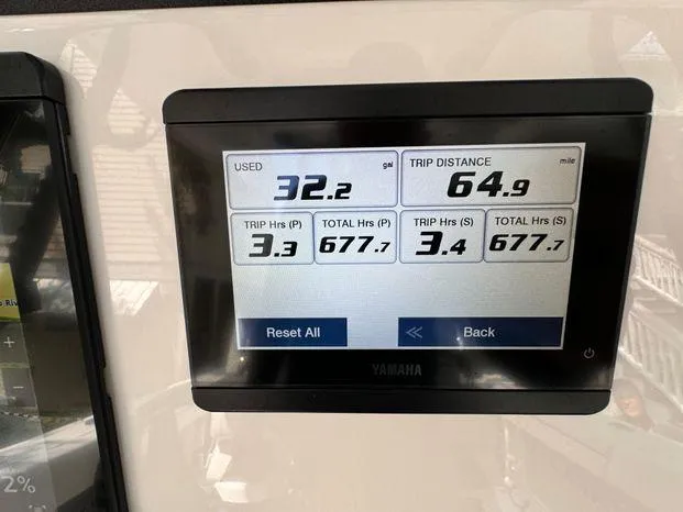 Slide: The Image of Yamaha display showing fuel usage and trip distance on 2021 Blackfin 252 CC boat. - 38
