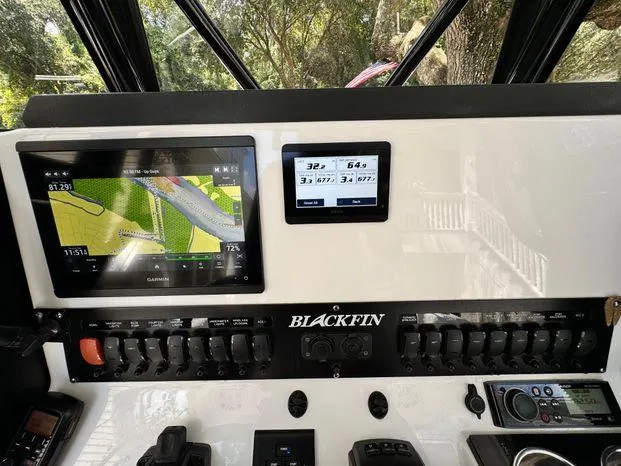 Slide: The Image of 2021 Blackfin 252 CC dashboard with navigation and control panels. - 39