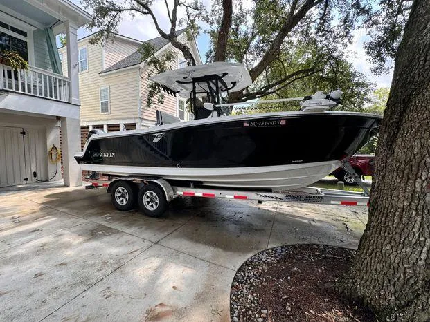 Slide: The Image of 2021 Blackfin 252 CC boat on trailer in residential driveway. - 4