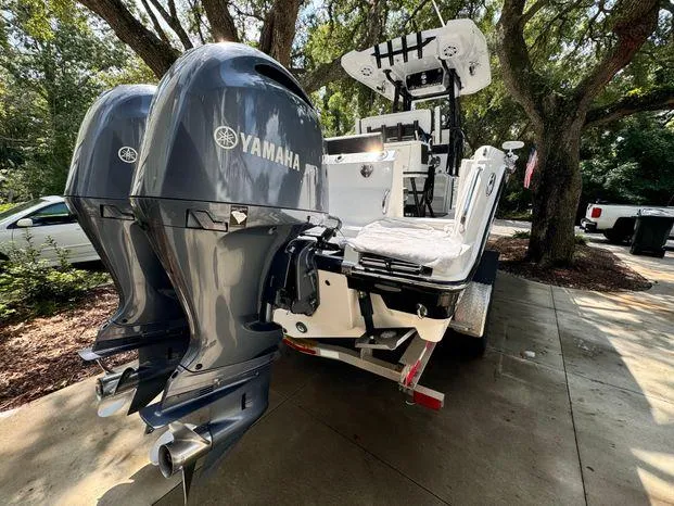 Slide: The Image of 2021 Blackfin 252 CC boat with dual Yamaha outboard engines, parked outdoors. - 5